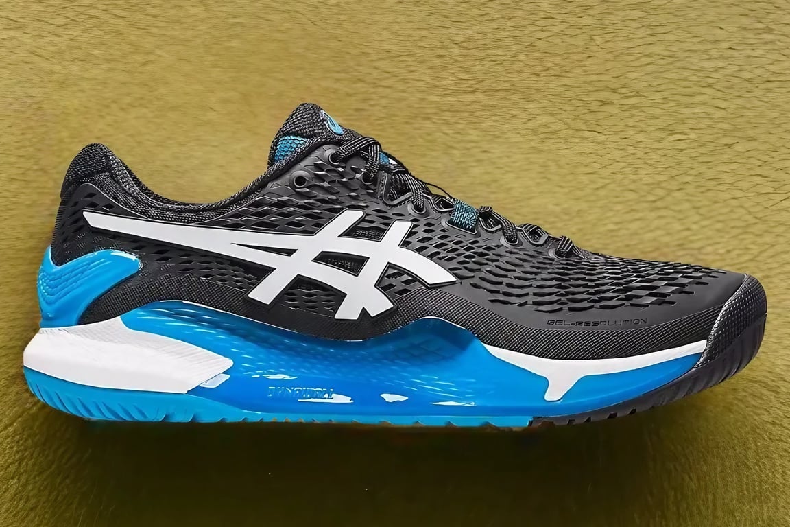 The Asics Gel Resolution 9 in front of the yellow wall.