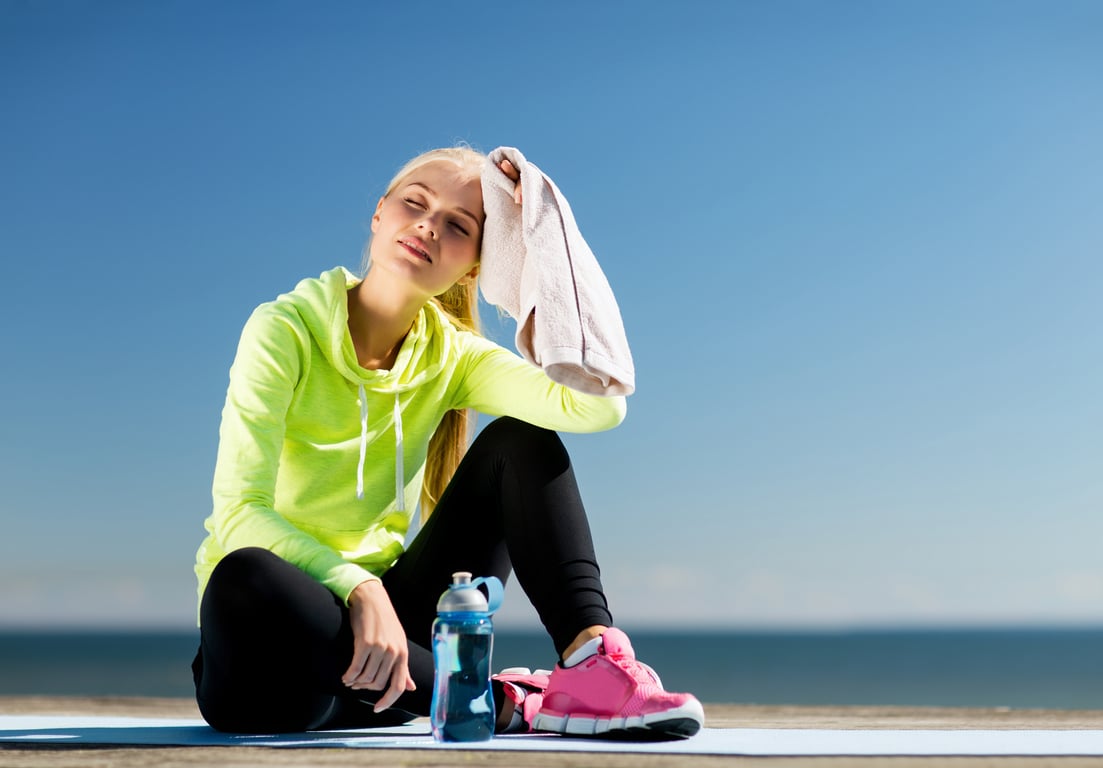 The woman is removing sweat from her head after the exercise.