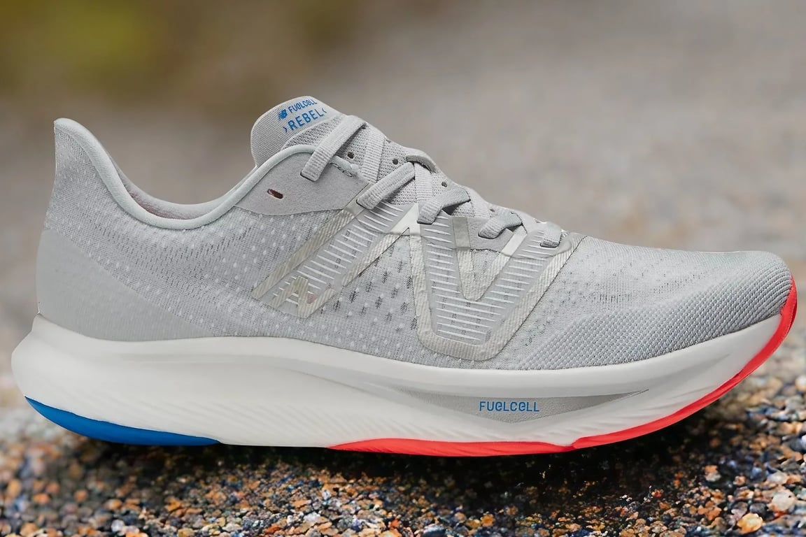 The New Balance Rebel running shoe on gravel.