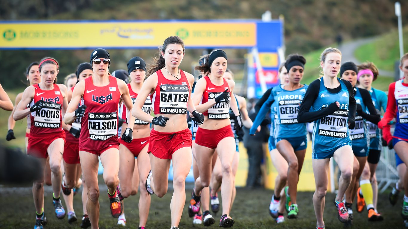 Two groups of women runners shortly after starting a 6K cross-country running race.