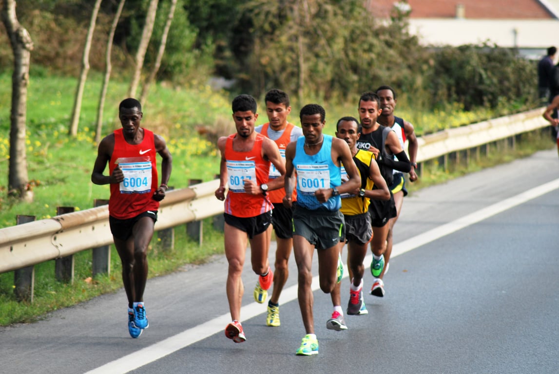 A group of skinny elite runner in the middle of the race.