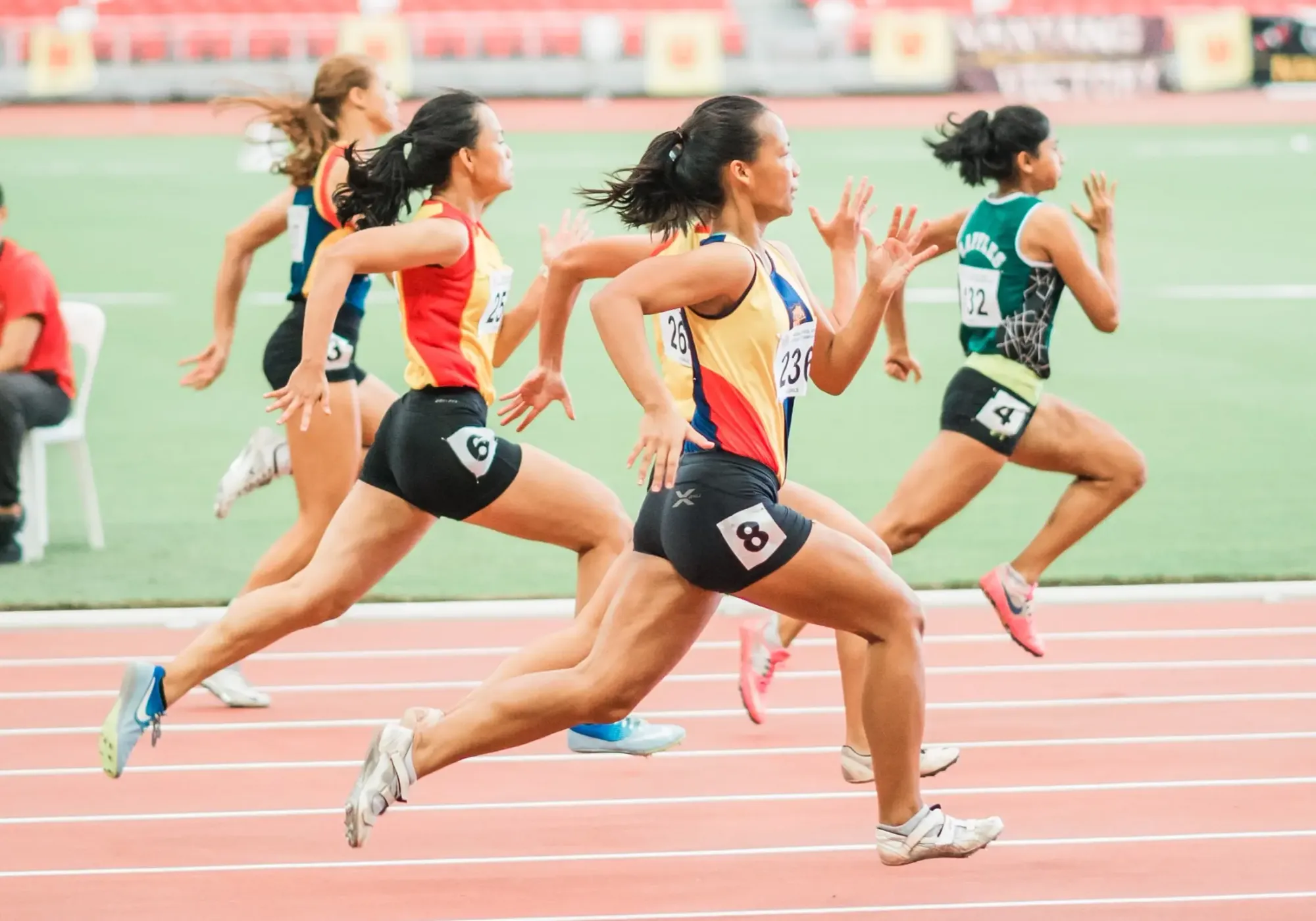 Elite runners in race on a track.